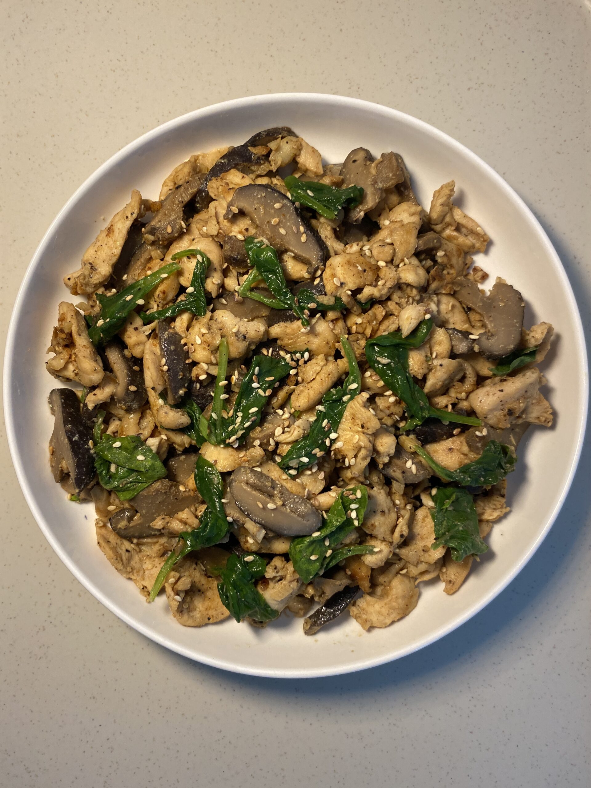 Japanese-inspired miso butter chicken with spinach and sliced shiitake mushrooms.