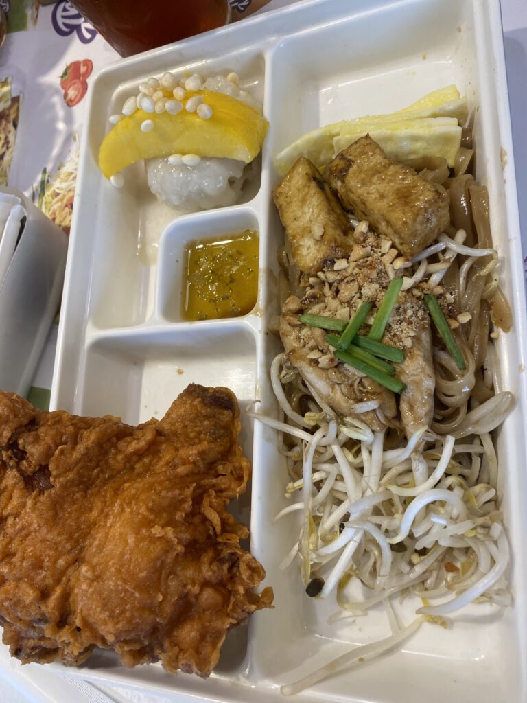 Set meal featuring Pad Thai, Thai Fried Chicken, Mango Sticky Rice, and Iced Tea