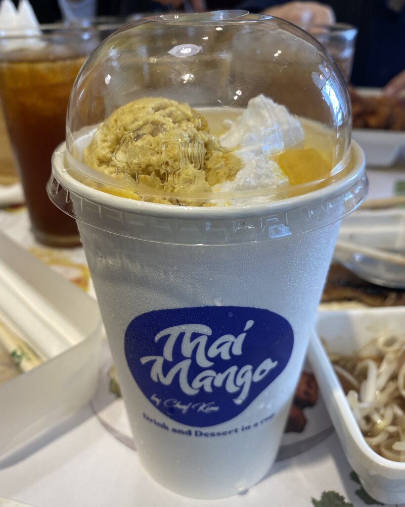 Thai Mango Classic smoothie with fresh mango slices, whipped cream, and homemade ice cream